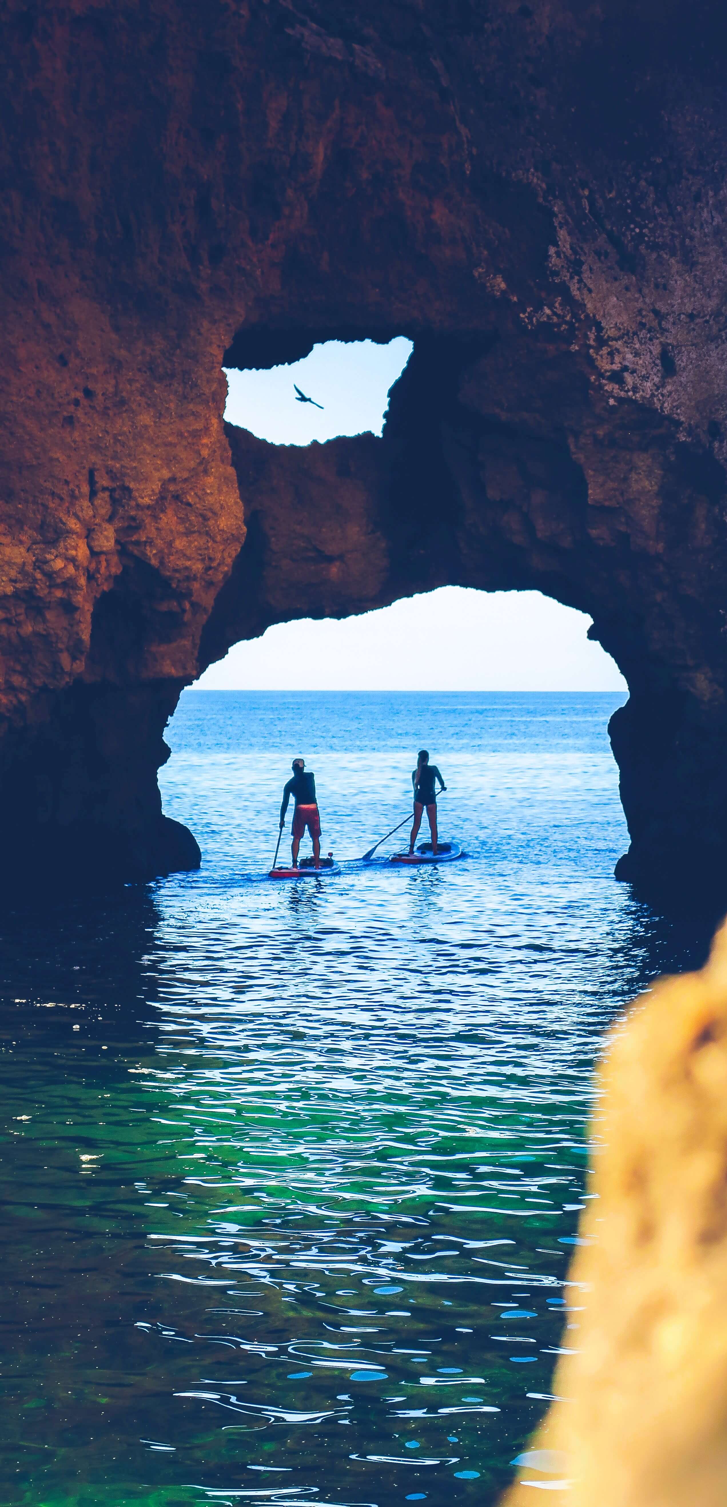paddle board on the ocean rocks max zed unsplash