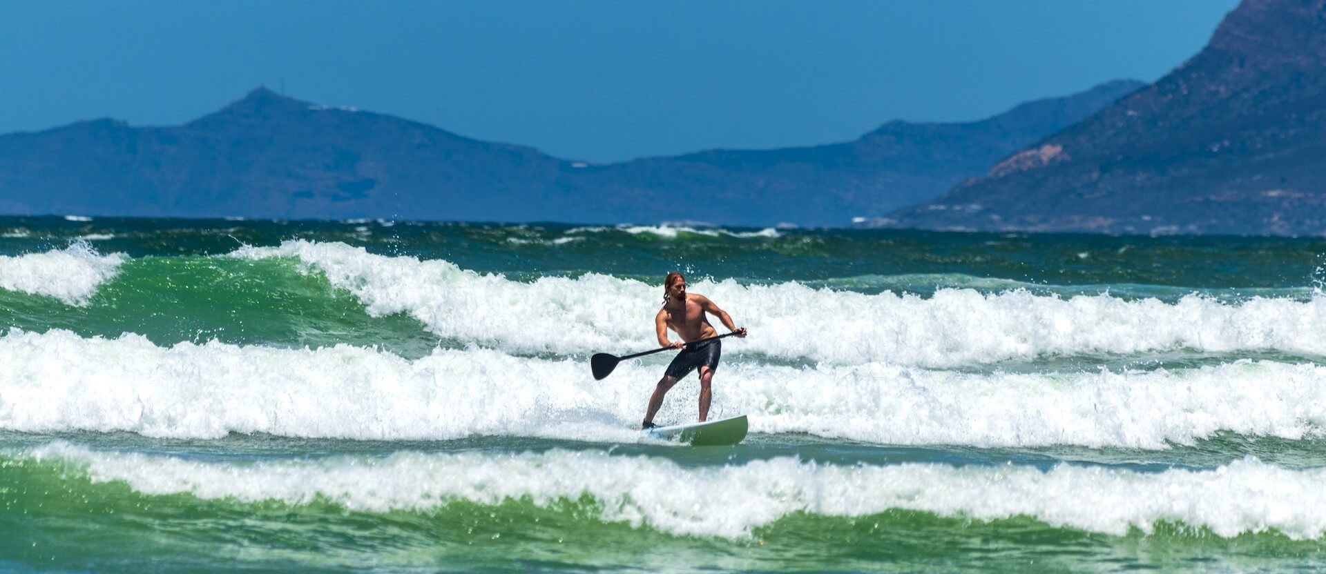 paddle boarding on the ocean grant durr unsplash